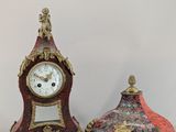 two clocks sitting next to each other on a table