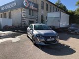 a car parked in front of a building with a truck in front of it