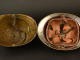 an old brass box with a snake in it on a black surface