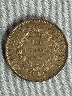 a close up of a coin on a cloth surface