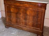 a wooden cabinet with a mirror on top of it
