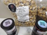 a bag of peanuts and two jars of peanut butter on a table