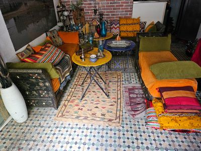 a living room with a lot of pillows and a rug