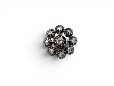 a black and white diamond flower broochle on a white background