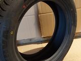 tires are stacked on the floor in a room with cardboard boxes