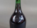 a brown bottle with a brown cap on top of it