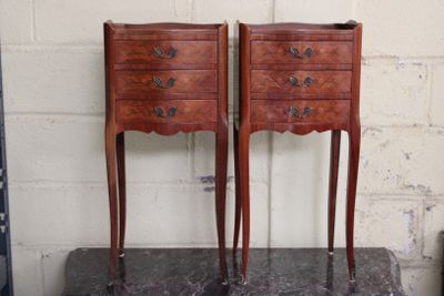 two small wooden chests on top of a marble table