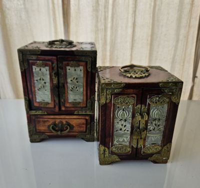 two small wooden boxes sitting next to each other on a table