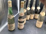 bottles of wine are lined up in a row on a counter