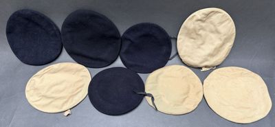 six hats are lined up in a row on a table