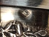 a close up of a metal object with a design on it