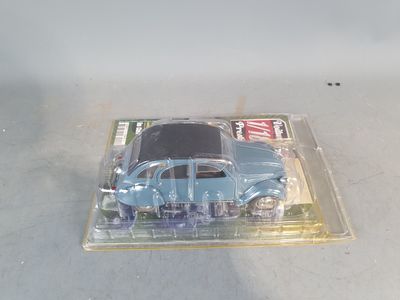 a blue toy car in a clear plastic box