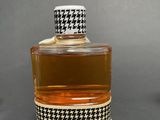 an image of a bottle of perfume sitting on top of a table