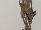 bronze statue of a man holding a baseball bat on a table