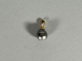 an image of a black pearl pendant on a white surface