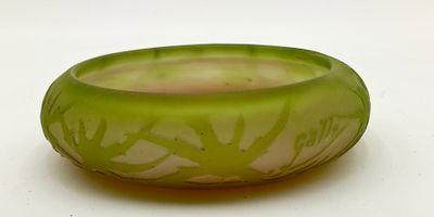 a green glass bowl with a tree design on it