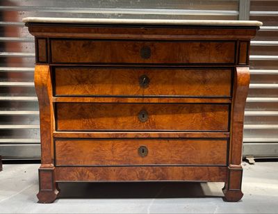 a small chest of drawers with a marble top