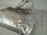 a silver purse that is sitting on a table