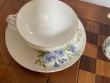 three cups and saucers sitting on a wooden table