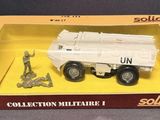 toy military vehicle in a box on a gray surface