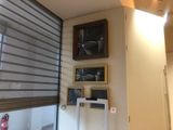 pictures on the wall above a window in a room