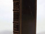 an old book that is sitting on a white surface
