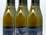 four bottles of wine are lined up on a white surface