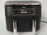 an air fryer sitting on top of a counter next to a wall