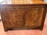a wooden chest with a drawer on top of it