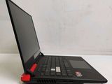 a black laptop with a red handle on a white table