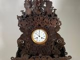 a wooden clock that is sitting on a table