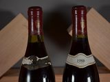 two bottles of wine sitting next to each other on a table