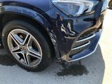 a close up of the front of a car with a denting tire