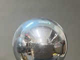a glass ball sitting on top of a wooden stand