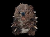 a small stuffed animal that is sitting on a black surface