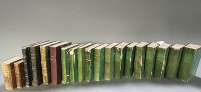 several old books stacked on top of each other on a table