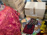many boxes of clothing and gloves on the floor