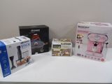 three boxes on a table with a coffee maker and a blender