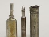 three old metal bottles are lined up next to each other