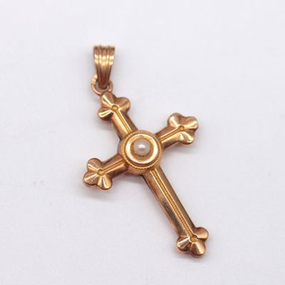 gold cross pendant with a pearl in the center