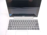 a laptop computer sitting on top of a white table
