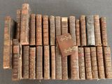 several old books stacked on top of each other on a table