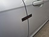 a close up of a car door handle with a sticker on it