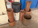 many different types of pipes sitting outside of a building