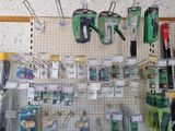 many tools hanging on a pegboard in a store