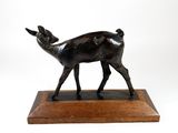 bronze sculpture of a deer on a wooden base