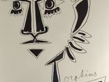 a black and white drawing of a face on a piece of paper