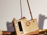 a wooden model of a boat on display on a table