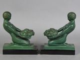 pair of art deco bookends of a man and a woman holding a basket of flowers