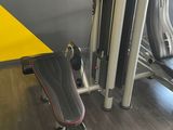 a yellow table and a black bench in a gym